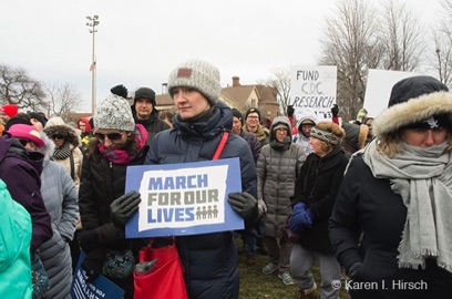 Woman holding sign March For Our Lives